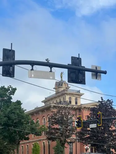 Historic architecture meets the city's pulse under a blue sky.